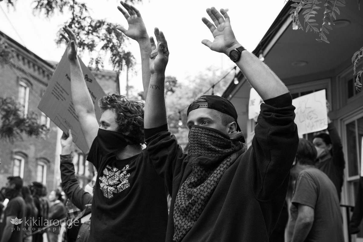 Men with hands up in the air at BLM rally protest