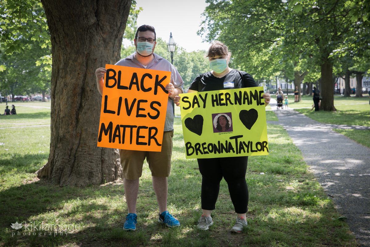Couple holding signs at Black Lives Matter rally on Salem Common