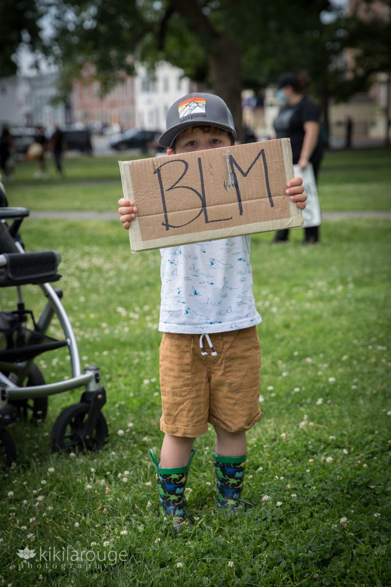 Young boy on common with BLM sign
