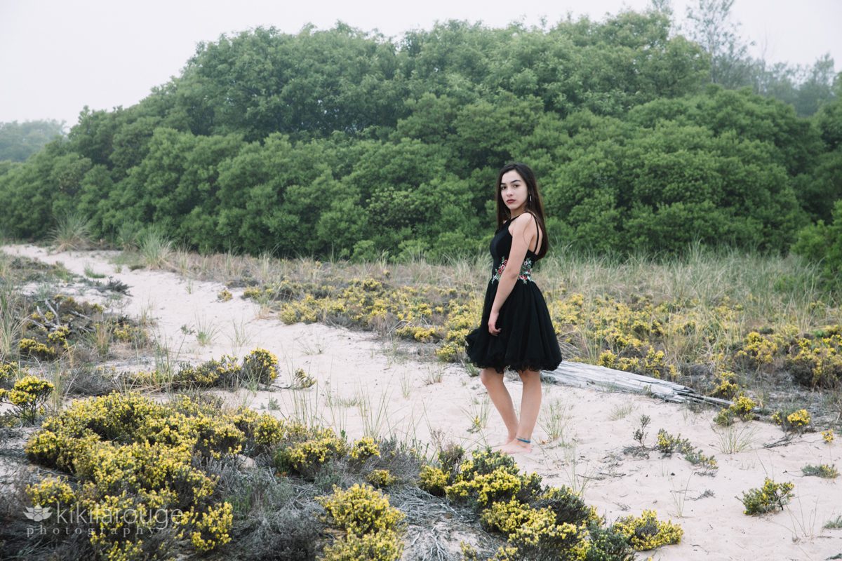 Girl in black dress in fog and dunes at Plum Island