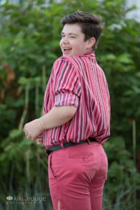 Teen boy looking over his shoulder with fun wink