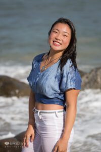 Girl soaking wet in white jeans smiling in sun