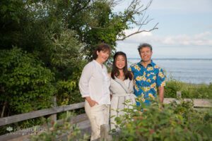 Teen girl with her parents on beach boardwalk