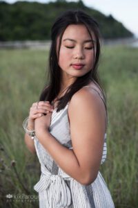 Pretty young girl with black hair holding hands at heart