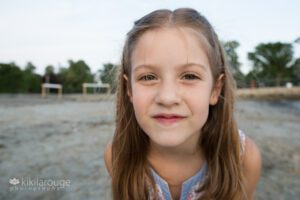 Close up wide angle portrait of young girl at beach