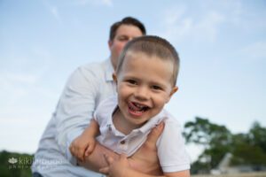 Young boy with tongue out smiling into the camera