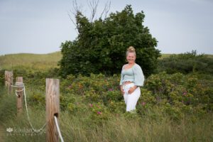 Girl in beach dunes with white jeans