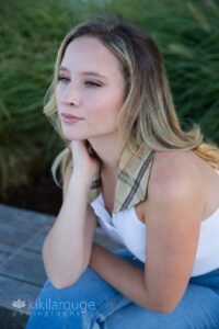 Girl sitting on stone wall Boston Looking into distance