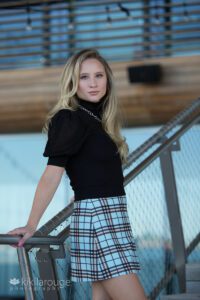 Girl plaid skirt on metal stairway