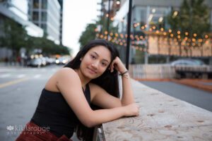 Girl leaning on wood barrier in Boston