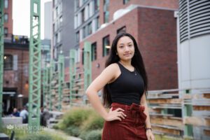 Teen girl red corduroy skirt on bench posing at Trillim Brewery