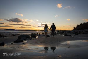 Young teen couple walking into the sunset silhouetted