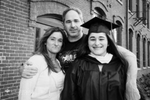 Mom and Dad with their daughter in her graduation cap and gown