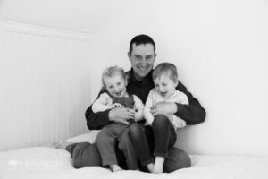 Dad tickling with two little boys