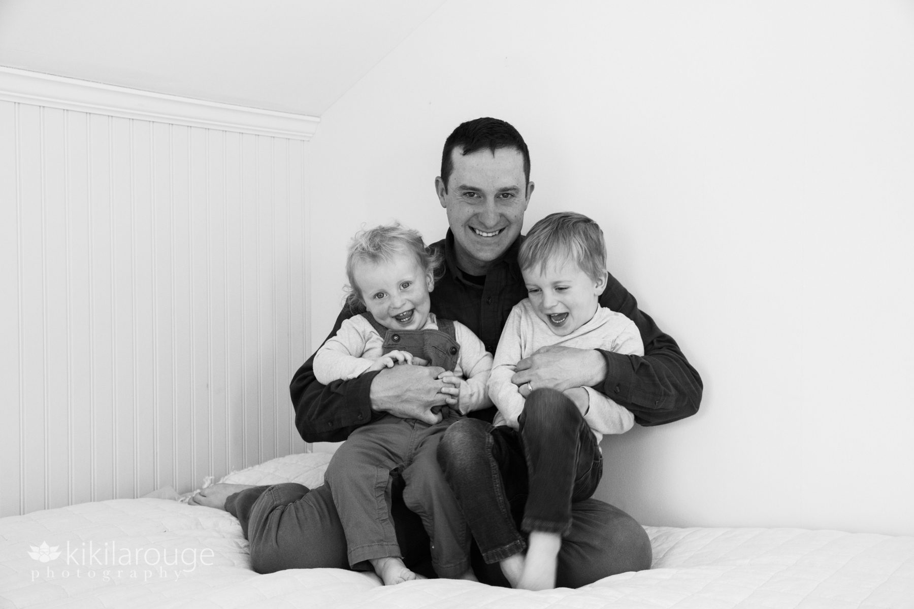 Dad tickling with two little boys