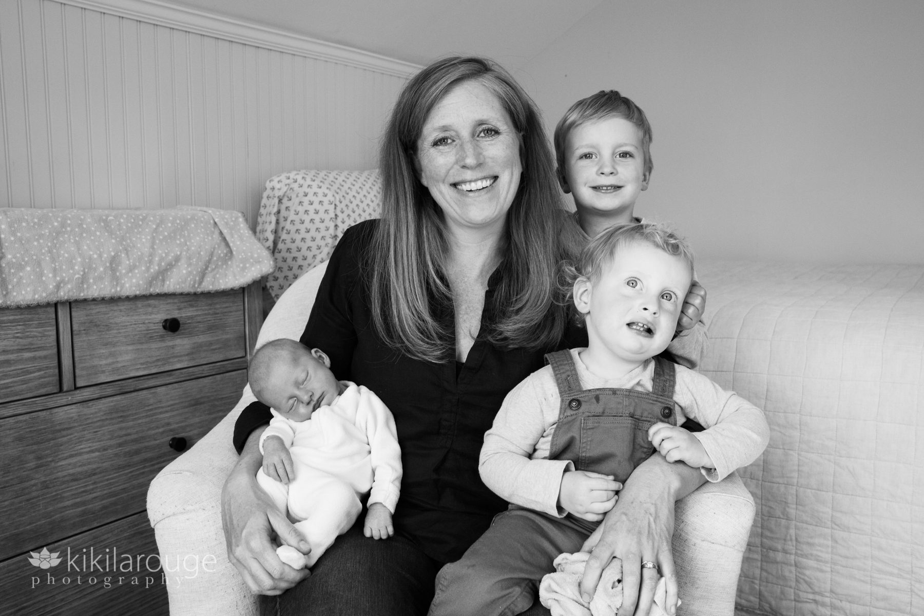 Mom in chair with three children including one newborn