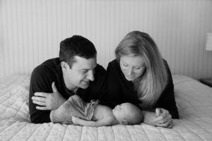 Mom and Dad looking down at sleeping newborn baby boy