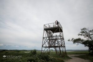 Couple on their wedding day on top of a Viewing tower Plum Island