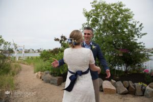 Bride and Groom at first look on sandy path