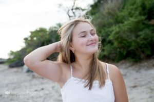 Teen girl smiling eyes closes at the beach