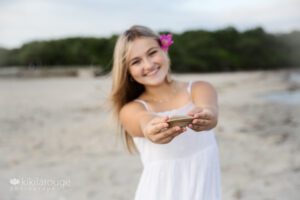 Girl in white summer dress holding clam shell