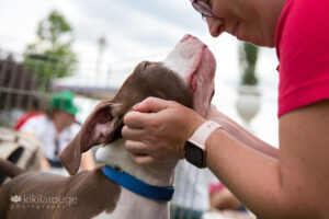 Women holding puppy's face