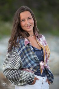 Senior portrait girl in plaid shirt and white shorts