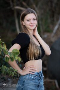 Senior girl portrait long blonde hair in jeans black top