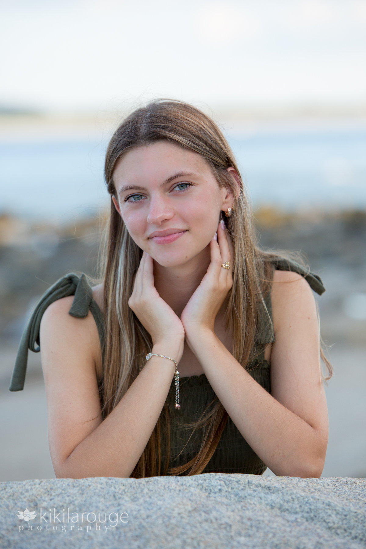 Girl smiling and leaning on rock at Bach