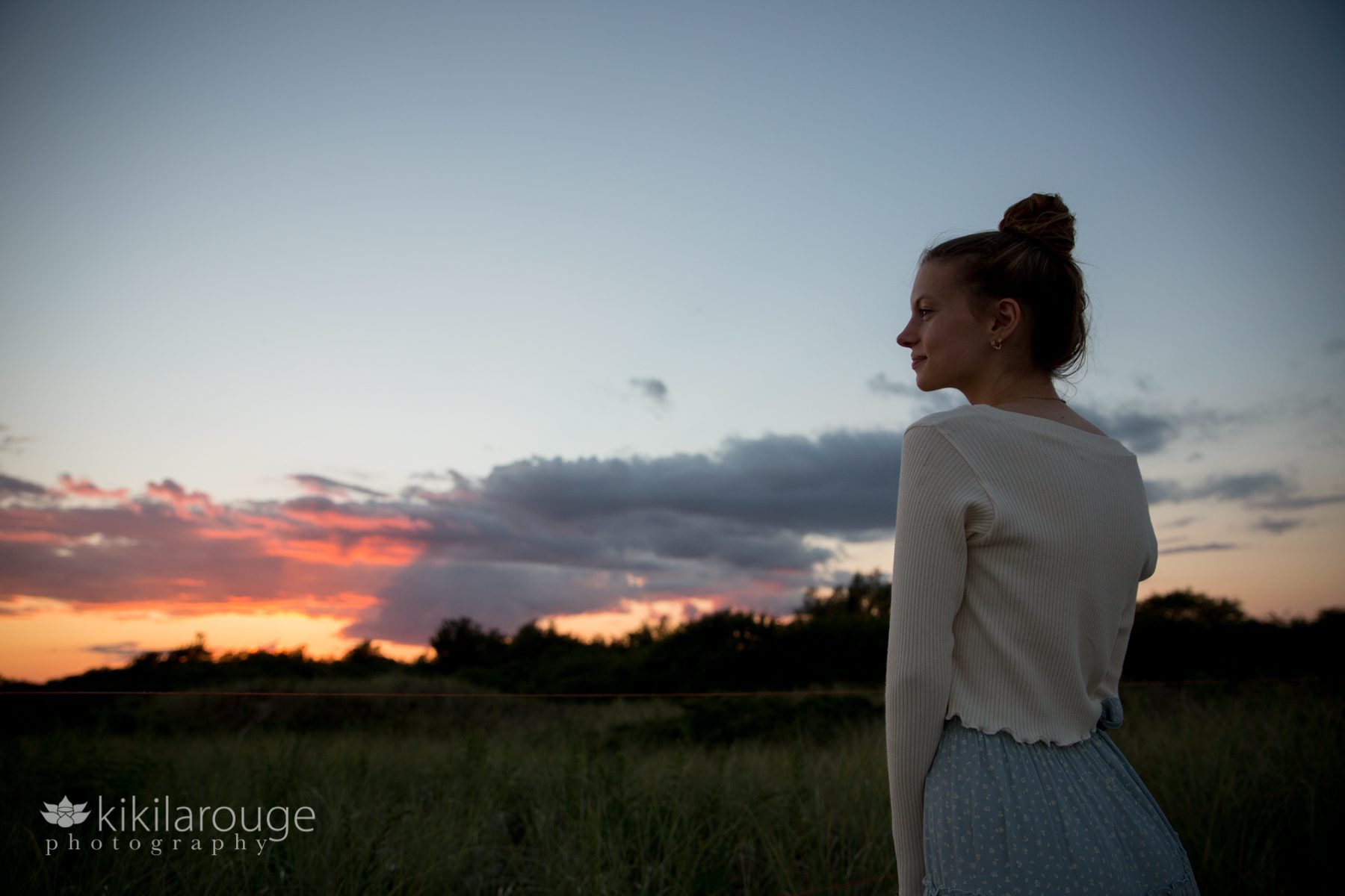 Girl looking in profile at beach sunset