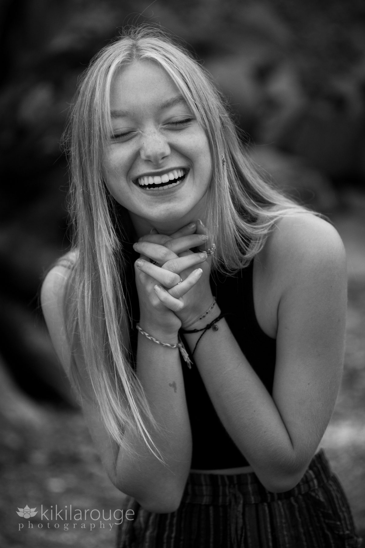 Blonde teen girl holding hands and laughing
