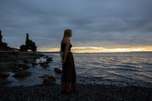 Teen girl at dramatic Seattle beach sunset