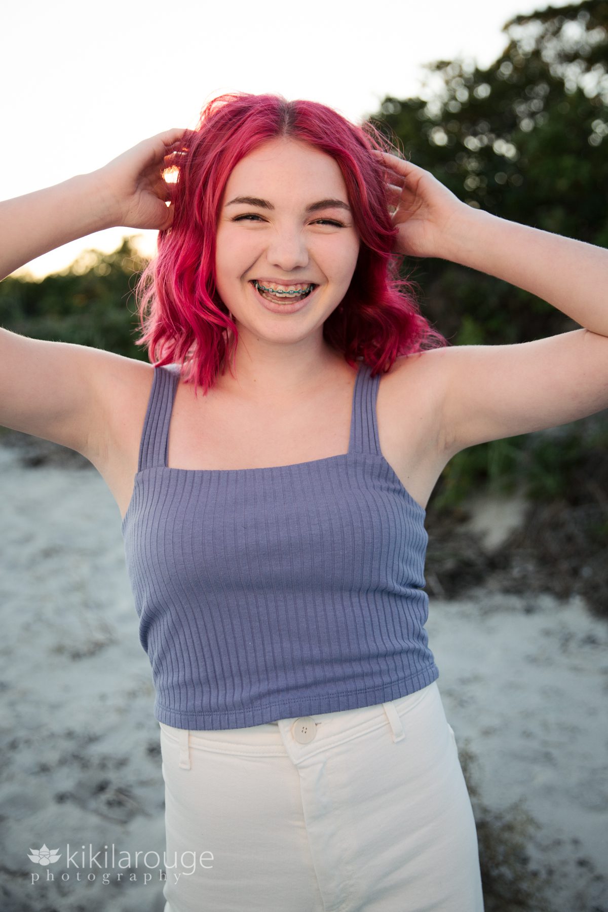 Teen girl with pink hair smiling