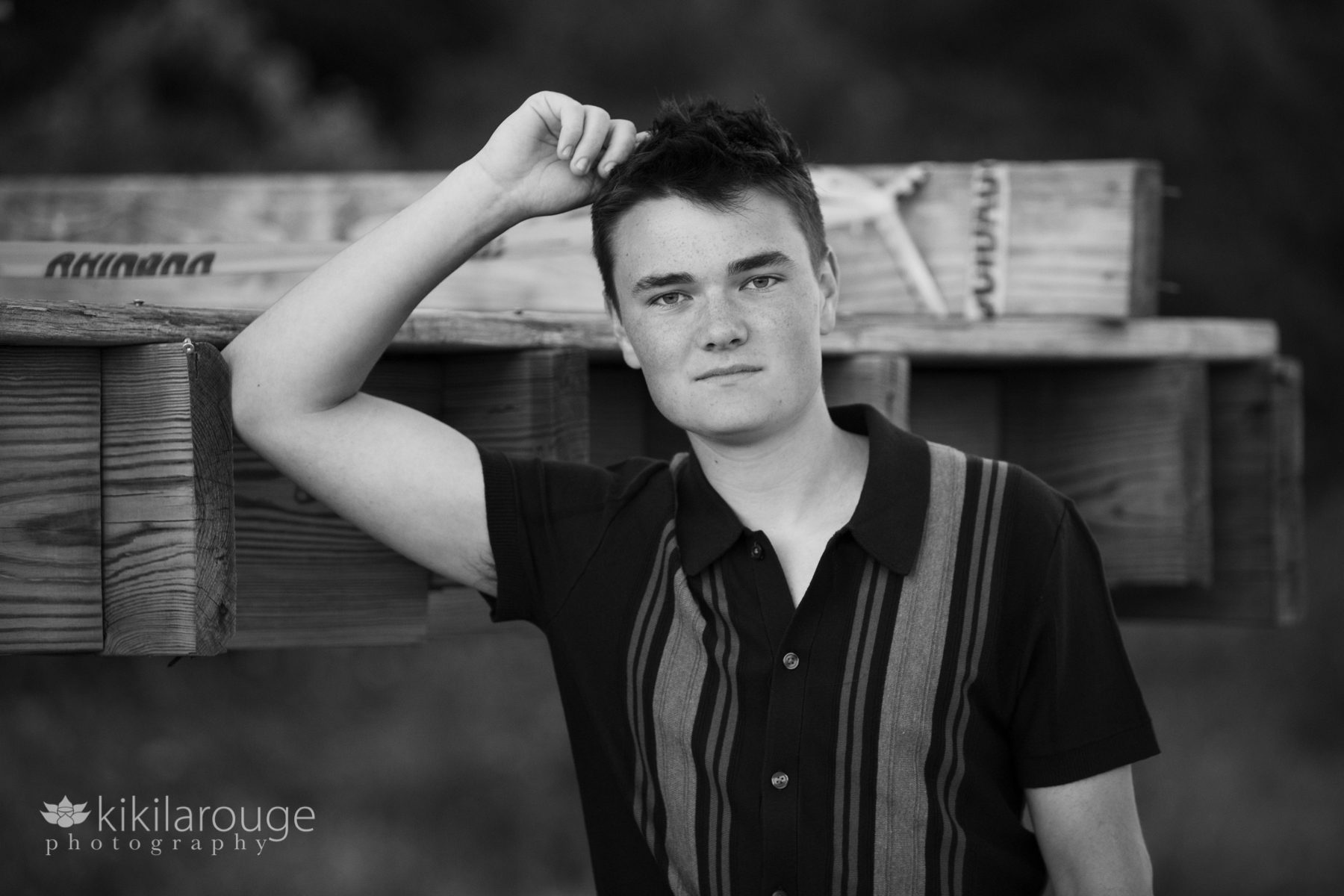 Teen boy Senior portrait arm up on beach walkway