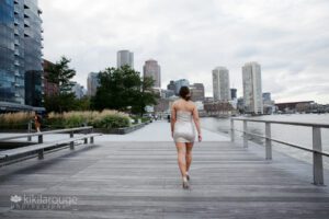 Girl walking the Boston Seaport walkway in sparkly dress