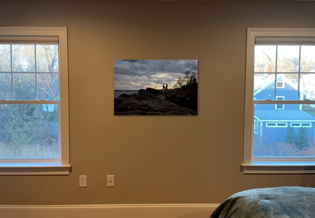Silhouette of couple on rocks in print on wall