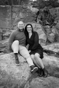 Couple sitting on rocky beach