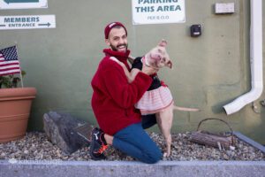 Pit bull hugging man in tutu