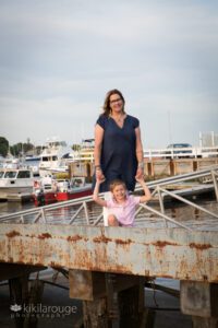 Mom and Son on pier at sunset