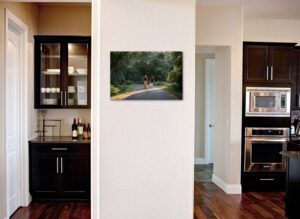 Wall art of couple walking away down road with white lab