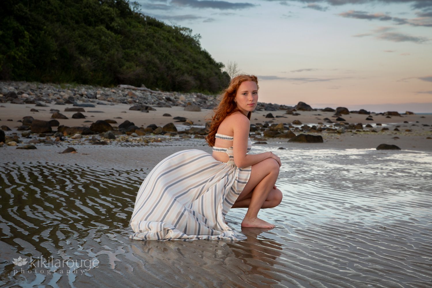 Girl in ripples at low tide at. beach with Forever 21 dress blowing