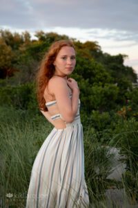 Redhead Senior girl in dunes at Sandy Point beach Plum Island