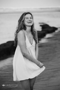 Girl laughing holding dress at Plum Island Beach Senior Portraits