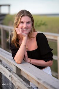 Senior Girl portrait on beach boardwalk black top