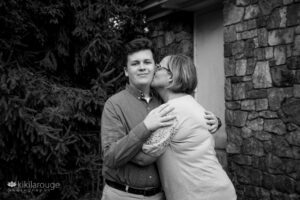 Mom kissing her teen senior boy on the cheek at Senior Photo Shoot