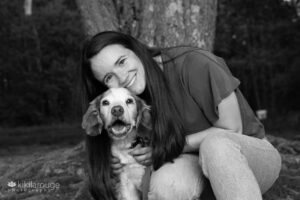 Girl hugging her senior dog Brittnay Spaniel