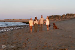 Family of four with dog on Plum Island beach during the golden hour