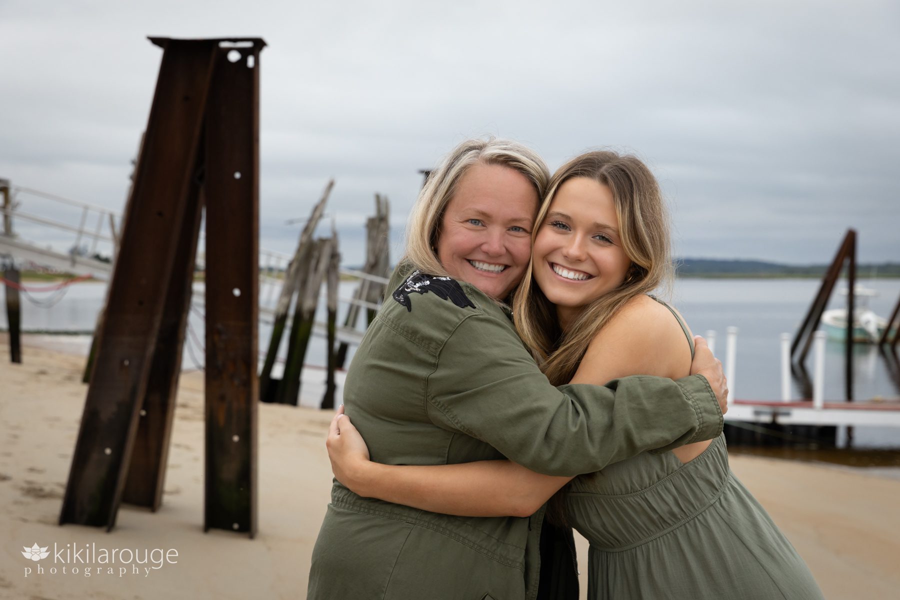Mom hugging Senior teen daughter on beach