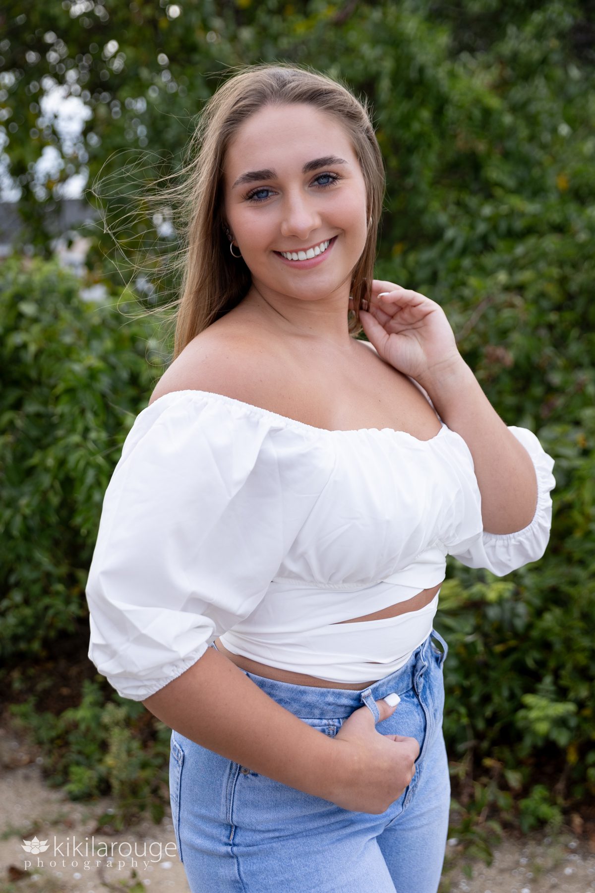 Triton Senior Portrait Girl in Jeans with white top tied in back at beach