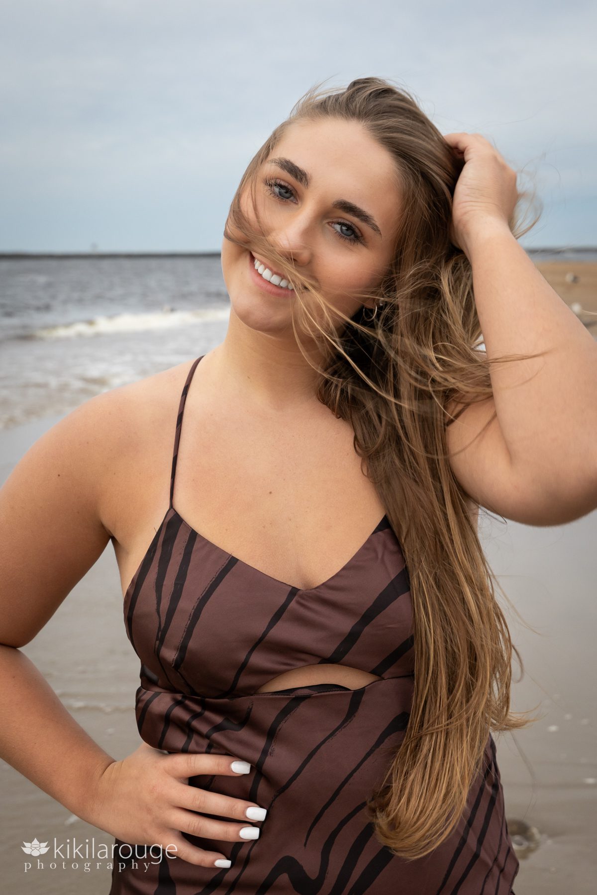 Girl in brown dress with hair blowing at Plum Island Beach